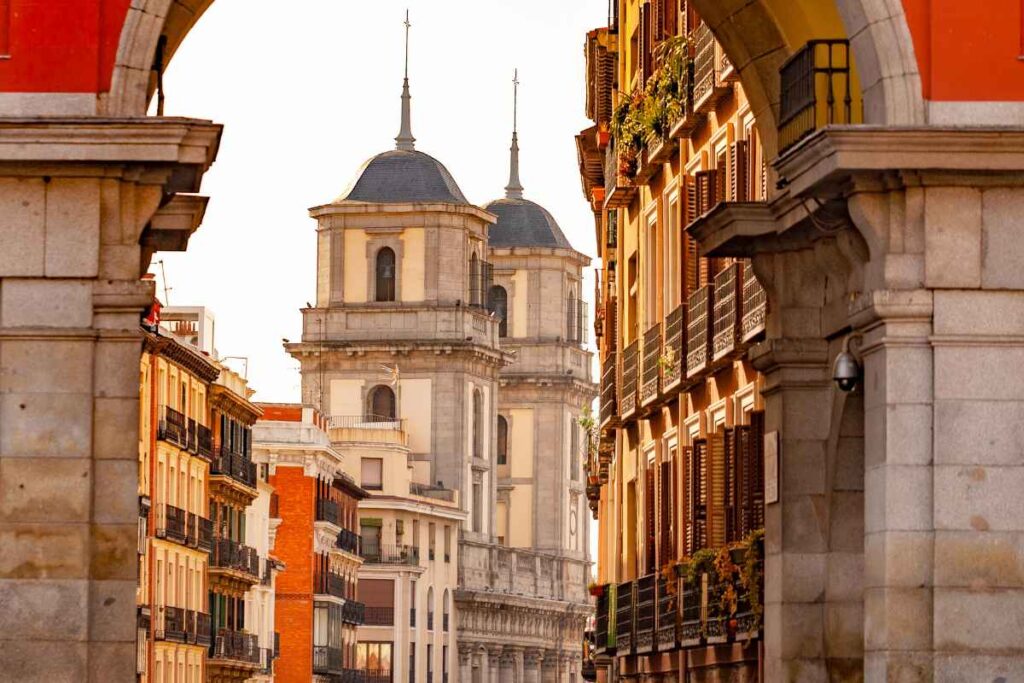 A framed view of Madrid’s historic architecture with the Almudena Cathedral towers in the background. A beautiful neighborhood for first-time visitors deciding where to stay in Madrid.